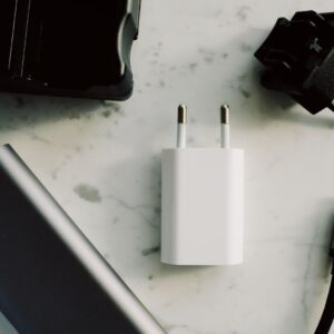 A collection of electronic adapters and chargers featuring USB-C and other connectors on a marble surface.