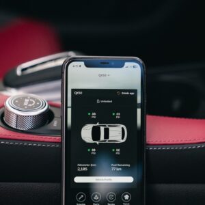 Smartphone displaying car diagnostics app on dashboard