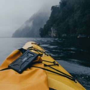 black smartphone with case on yellow kayak on water during daytime