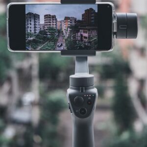 selective focus photography of iphone taking photo of city buildings during daytime