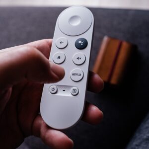 a person holding a remote control in their hand