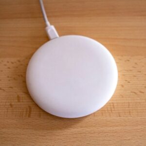 white round device on brown wooden table