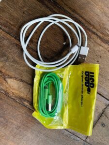 a couple of cords and a bag on a wooden floor