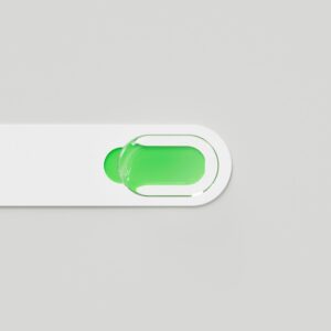 A green droplet on a white, curved bar.