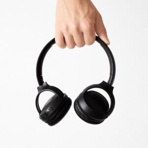person holding black and gray wireless headphones